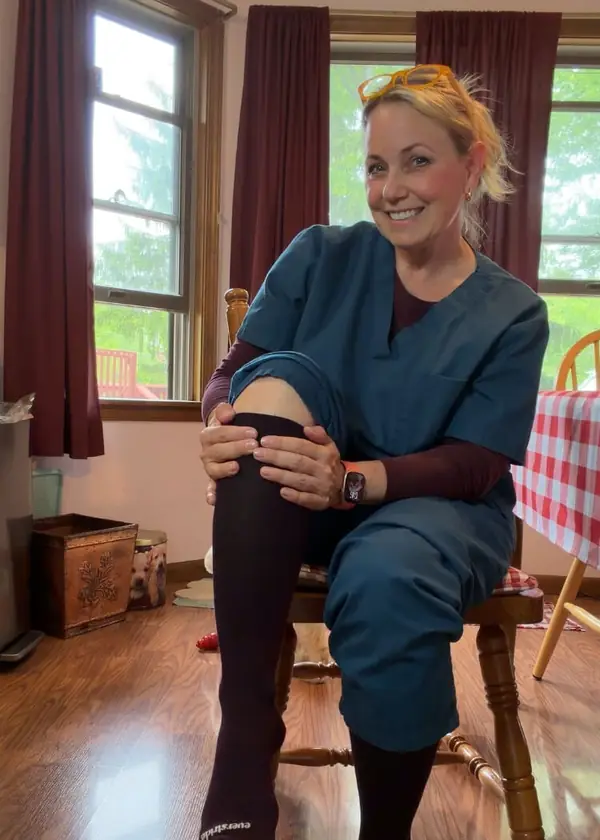 Nurse pulling on her Everstride compression socks before a shift